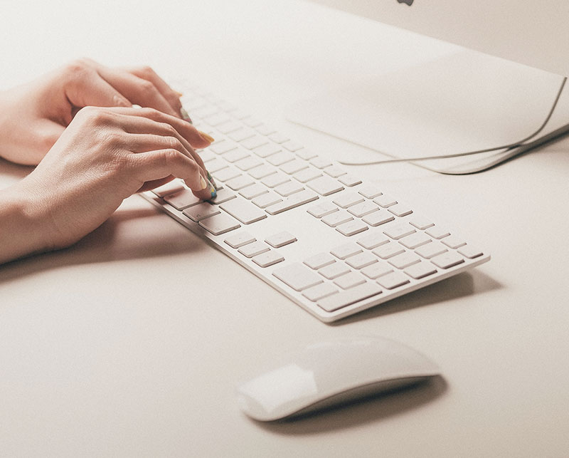 Woman typing on a computer keyboard