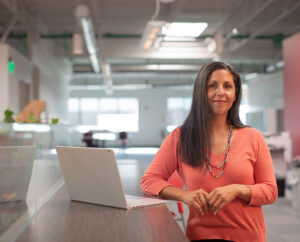 On premises software solution Woman standing next to a computer in an office